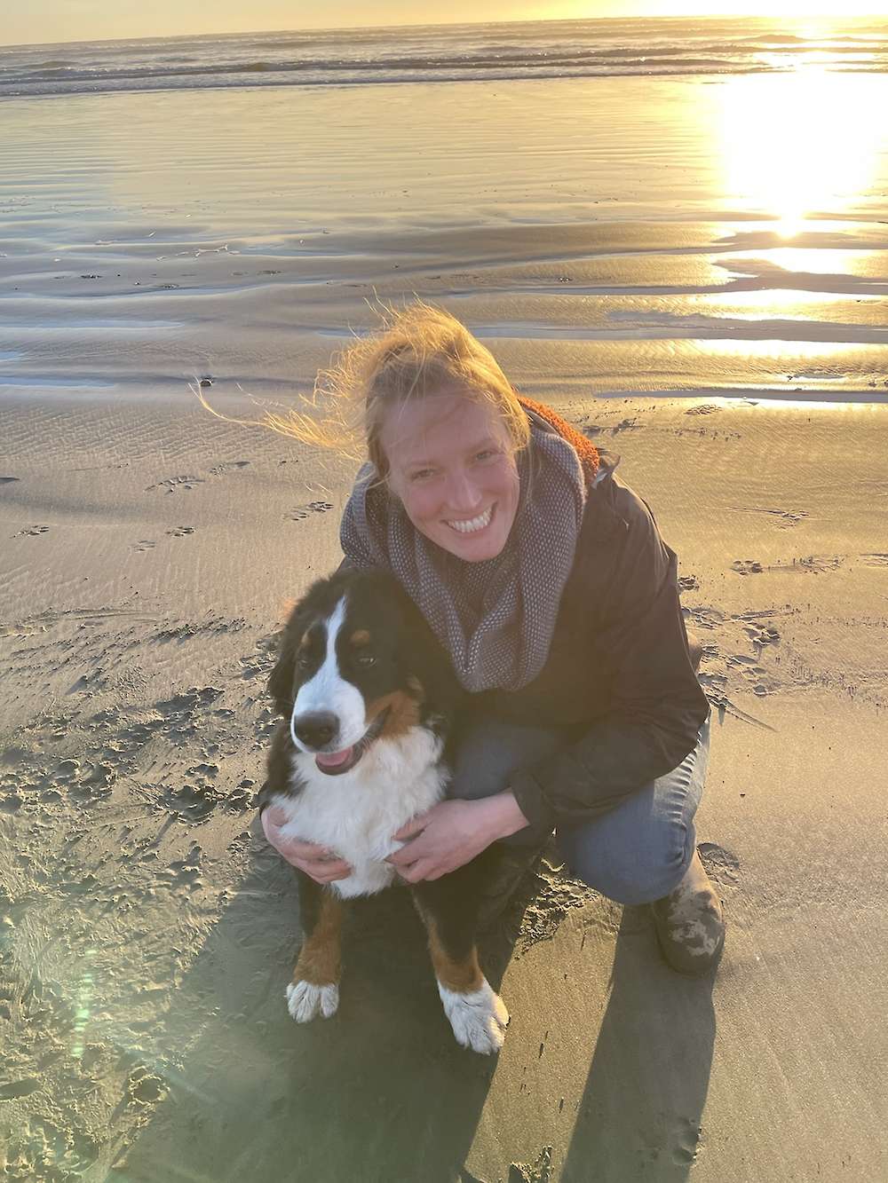 Karin with a Bernese Mountain Dog on the beach